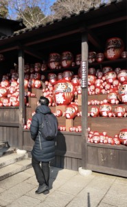 Hundreds of red Daruma dolls symbolizing luck at Katsuoji Temple in Osaka